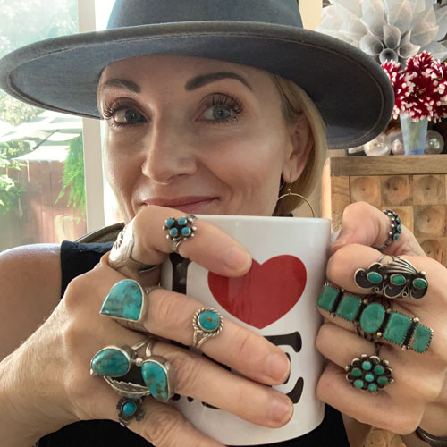 Heather Briggs holding a mug with a smile